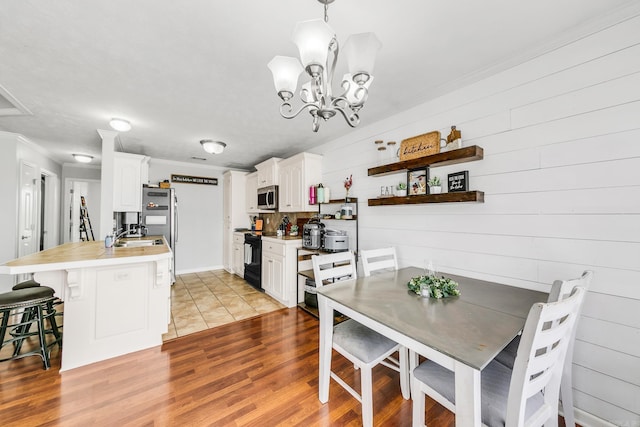 142 Peach St, Austin, AR 72007 - dining space with a chandelier, light wood finished floors, and ornamental molding