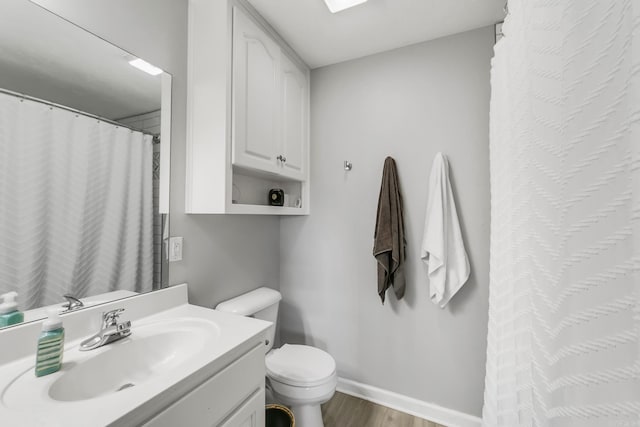 142 Peach St, Austin, AR 72007 - full bath with toilet, wood finished floors, vanity, and baseboards