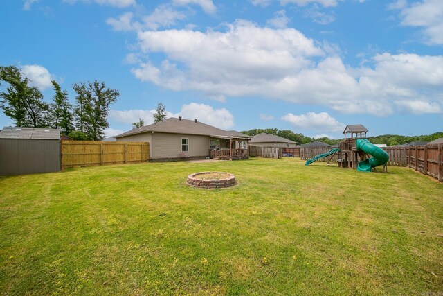 142 Peach St, Austin, AR 72007 - view of yard with a playground, a shed, an outdoor fire pit, and an outdoor structure
