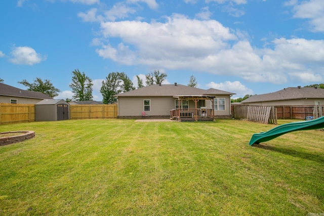 142 Peach St, Austin, AR 72007 - back of property featuring a shed, a deck, an outbuilding, and a playground
