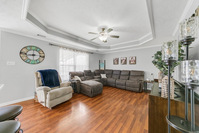 142 Peach St, Austin, AR 72007 - living room with a tray ceiling, wood finished floors, crown molding, a ceiling fan, and baseboards