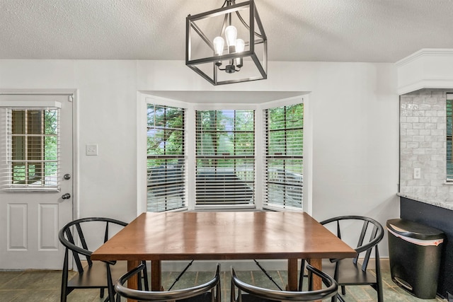 4 Desoto Forest Cv, Little Rock, AR 72211 - dining space with a textured ceiling and a chandelier