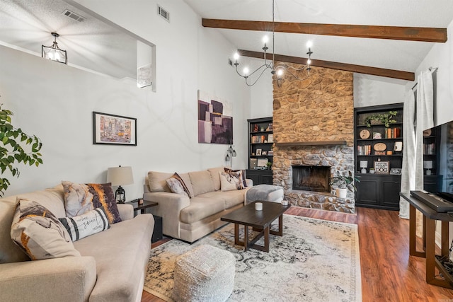 4 Desoto Forest Cv, Little Rock, AR 72211 - living area with wood finished floors, beamed ceiling, a chandelier, a fireplace, and high vaulted ceiling