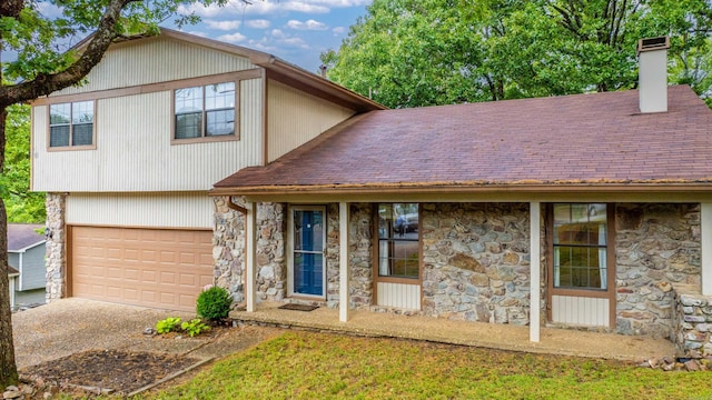 4 Desoto Forest Cv, Little Rock, AR 72211 - view of front of property featuring stone siding, roof with shingles, an attached garage, a chimney, and driveway