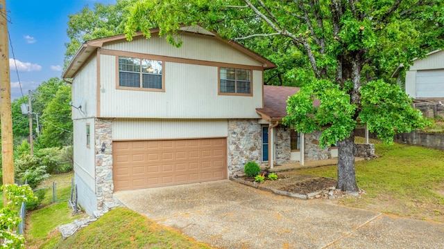 4 Desoto Forest Cv, Little Rock, AR 72211 - view of front facade with stone siding, a garage, concrete driveway, and roof with shingles