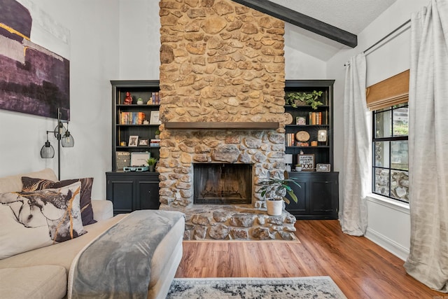 4 Desoto Forest Cv, Little Rock, AR 72211 - living room featuring wood finished floors and a stone fireplace