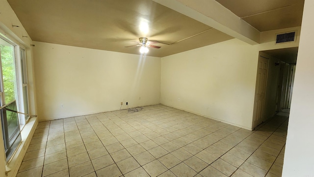 spare room with a ceiling fan and light tile patterned floors