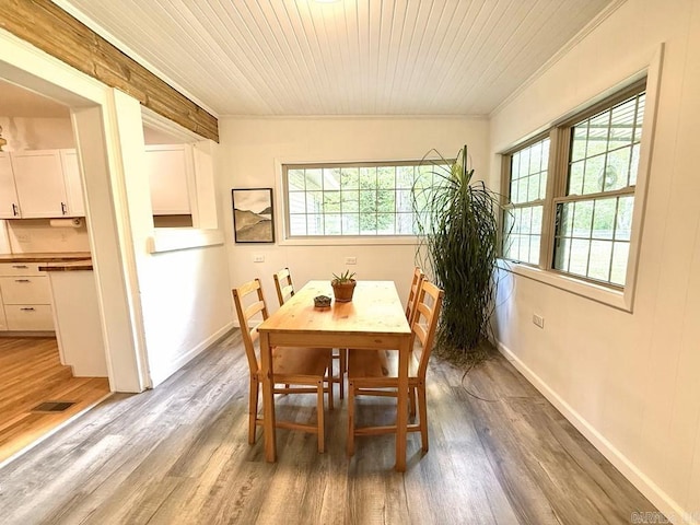 601 Clarence St, Mountain View, AR 72560 - dining space with wooden ceiling, healthy amount of natural light, wood finished floors, crown molding, and baseboards