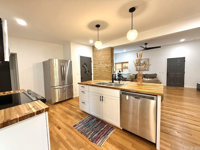 601 Clarence St, Mountain View, AR 72560 - kitchen featuring wood counters, stainless steel appliances, a sink, white cabinets, and light wood-style floors