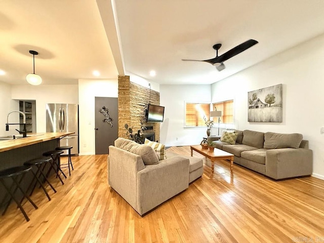 601 Clarence St, Mountain View, AR 72560 - living room with ceiling fan, light wood-type flooring, recessed lighting, a brick fireplace, and baseboards