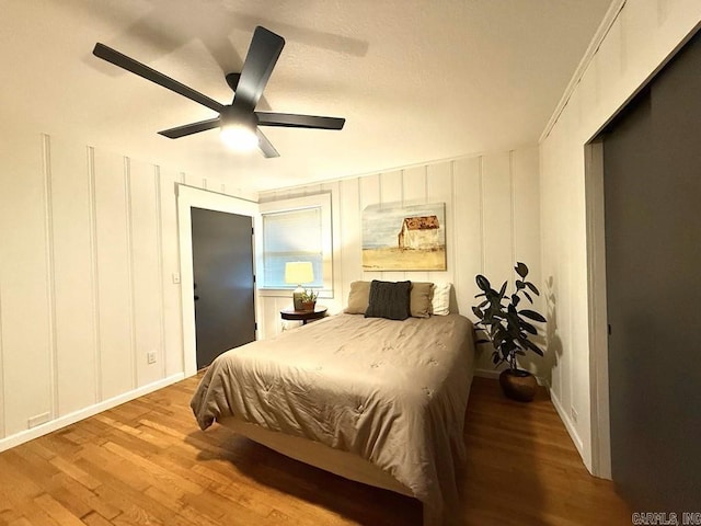 601 Clarence St, Mountain View, AR 72560 - bedroom featuring a decorative wall, wood finished floors, and ceiling fan