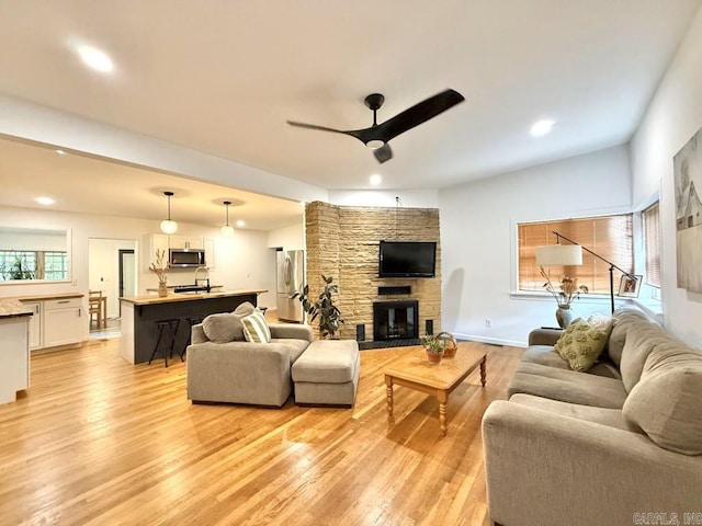 601 Clarence St, Mountain View, AR 72560 - living area with ceiling fan, light wood-style floors, a stone fireplace, and recessed lighting