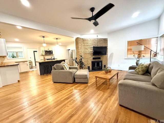 601 Clarence St, Mountain View, AR 72560 - living room with a ceiling fan, light wood-style flooring, a fireplace, and recessed lighting