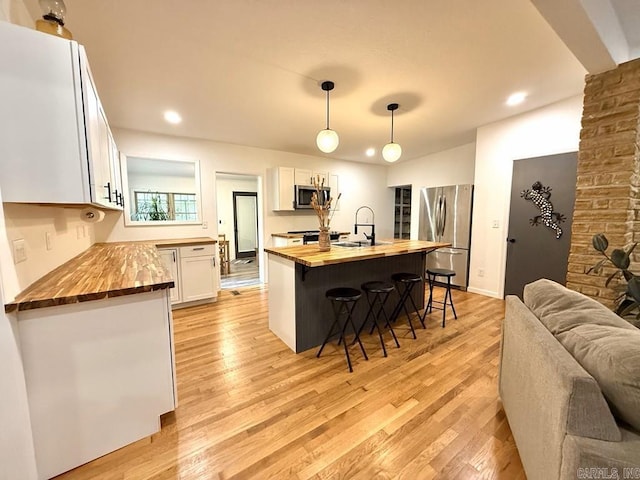 601 Clarence St, Mountain View, AR 72560 - kitchen with butcher block counters, stainless steel appliances, light wood-type flooring, and recessed lighting