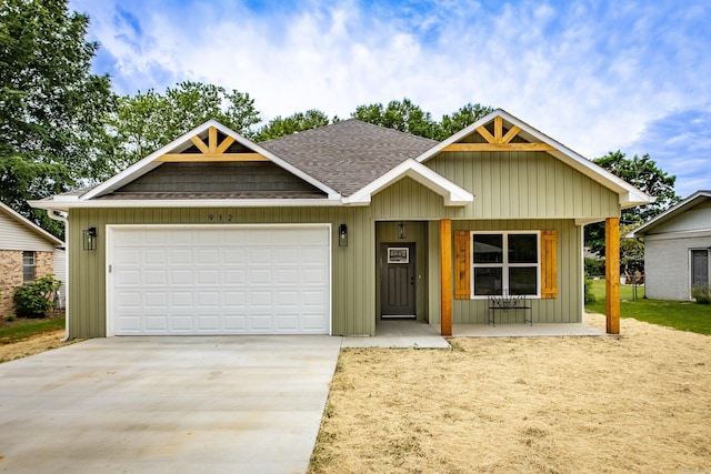912 Lakeshore Dr, Heber Springs, AR 72543 - view of front of home with driveway, roof with shingles, a garage, and covered porch
