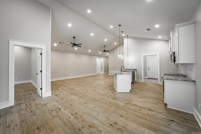 912 Lakeshore Dr, Heber Springs, AR 72543 - kitchen with a sink, a ceiling fan, stainless steel appliances, white cabinetry, and open floor plan