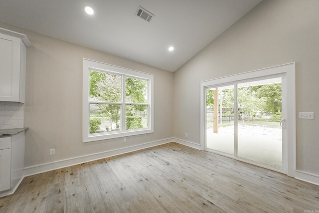 912 Lakeshore Dr, Heber Springs, AR 72543 - unfurnished dining area featuring light wood-style floors, recessed lighting, baseboards, and high vaulted ceiling