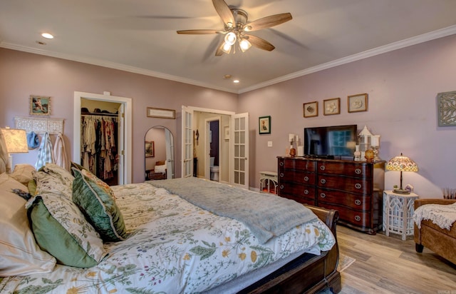 12420 Brodie Creek Trl, Little Rock, AR 72211 - bedroom with wood finished floors, crown molding, a walk in closet, french doors, and a closet