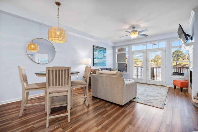 living room featuring french doors, a ceiling fan, wood finished floors, and baseboards