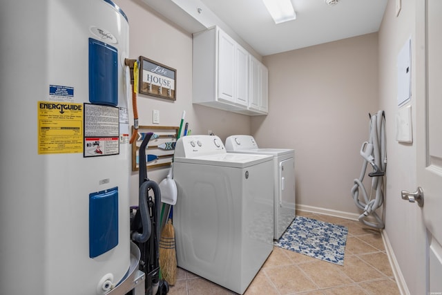 clothes washing area with cabinet space, washer and dryer, light tile patterned flooring, baseboards, and electric water heater