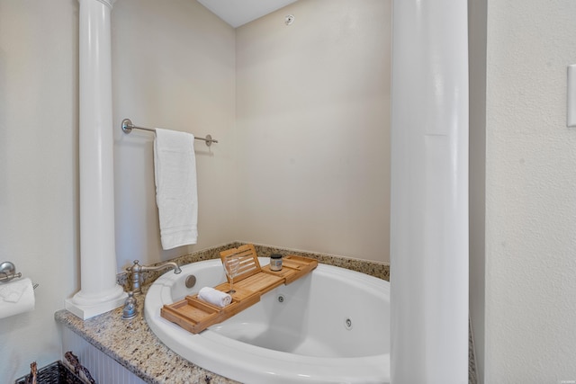 bathroom with a tub with jets