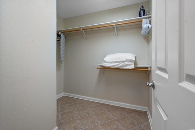 walk in closet with tile patterned floors