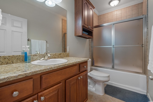 full bath with tile patterned flooring, ornamental molding, vanity, toilet, and bath / shower combo with glass door