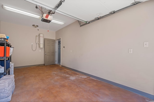 garage with a garage door opener and baseboards