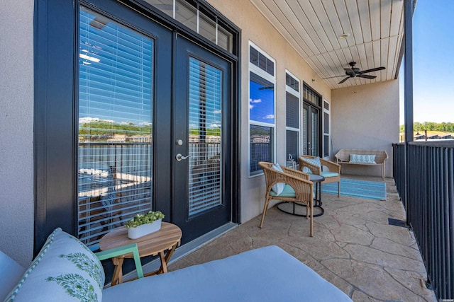 view of patio / terrace featuring french doors, a ceiling fan, and a balcony
