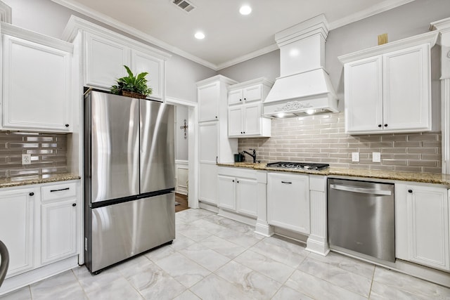 2724 Crooked Stick Dr, Benton, AR 72015 - kitchen with stainless steel appliances, custom range hood, white cabinets, crown molding, and recessed lighting