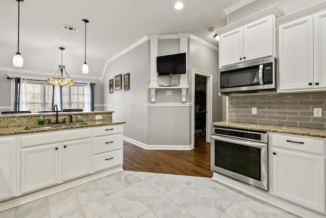 2724 Crooked Stick Dr, Benton, AR 72015 - kitchen with appliances with stainless steel finishes, a sink, crown molding, lofted ceiling, and white cabinetry