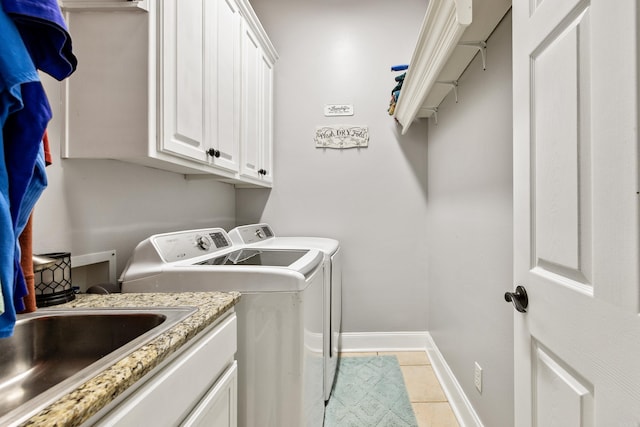 2724 Crooked Stick Dr, Benton, AR 72015 - clothes washing area with washing machine and clothes dryer, baseboards, light tile patterned floors, and cabinet space
