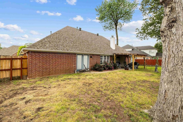 2724 Crooked Stick Dr, Benton, AR 72015 - back of house featuring roof with shingles, a chimney, brick siding, and a patio