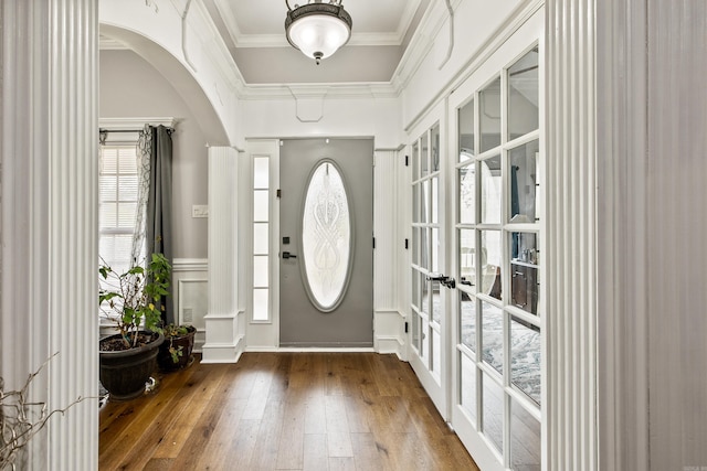 2724 Crooked Stick Dr, Benton, AR 72015 - foyer featuring wood-type flooring, healthy amount of natural light, ornamental molding, and arched walkways