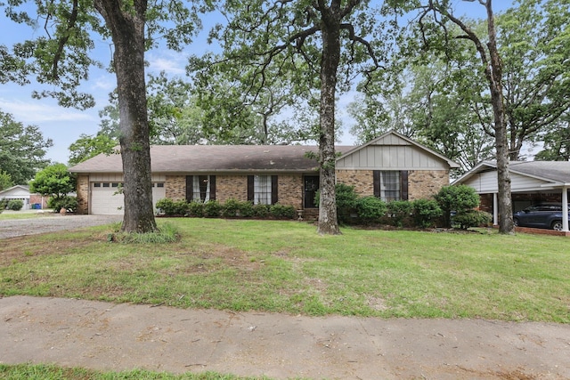 single story home featuring driveway, brick siding, and a front yard