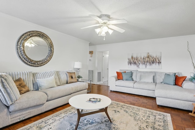 living area with ornamental molding and ceiling fan
