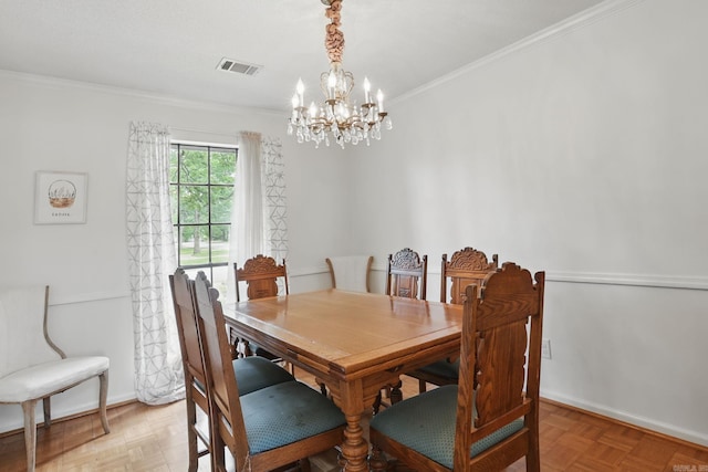 dining space featuring a chandelier, crown molding, and baseboards
