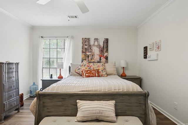 bedroom with wood finished floors, ornamental molding, baseboards, and a ceiling fan