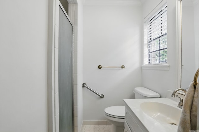 full bath featuring toilet, vanity, an enclosed shower, baseboards, and tile patterned flooring