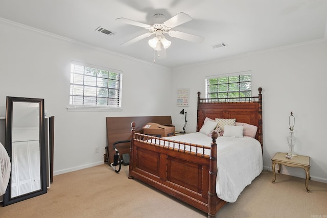 bedroom featuring light colored carpet, ornamental molding, baseboards, and a ceiling fan