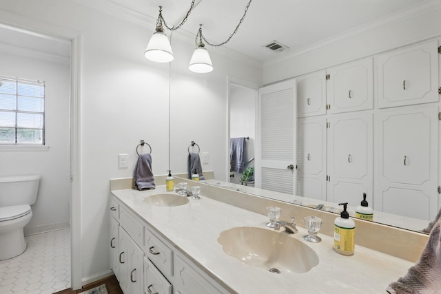 full bathroom with ornamental molding, toilet, double vanity, baseboards, and tile patterned flooring