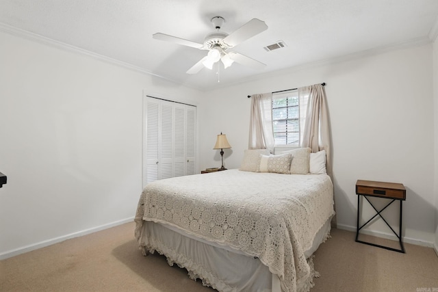 bedroom featuring light carpet, a closet, ornamental molding, baseboards, and ceiling fan