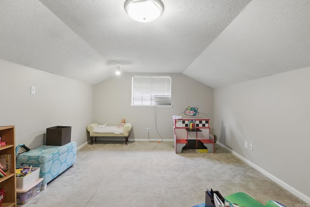 game room featuring carpet, a textured ceiling, lofted ceiling, and baseboards