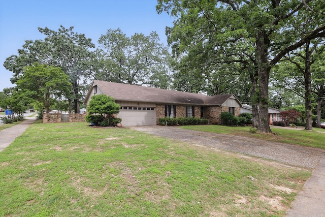 view of front of house featuring a garage, asphalt driveway, brick siding, and a front yard
