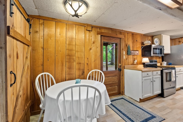 112 Fairchild Pt, Hot Springs, AR 71901 - dining room featuring wooden walls and light wood-style flooring