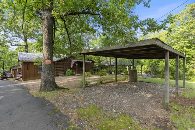 112 Fairchild Pt, Hot Springs, AR 71901 - surrounding community with a detached carport, asphalt driveway, and an outbuilding