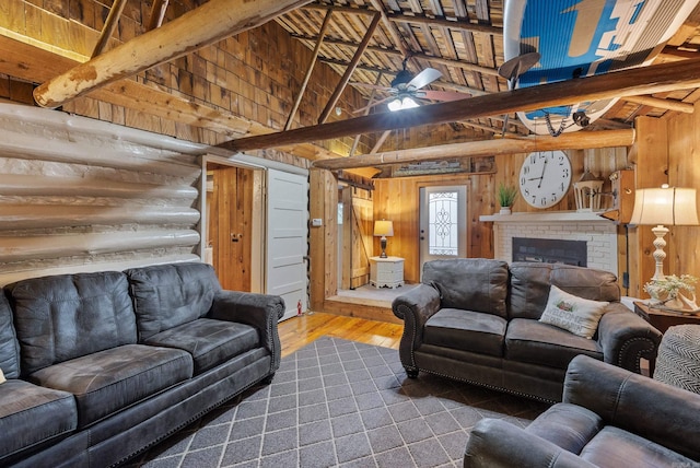 112 Fairchild Pt, Hot Springs, AR 71901 - living room featuring high vaulted ceiling, wooden walls, dark wood-type flooring, a ceiling fan, and a brick fireplace