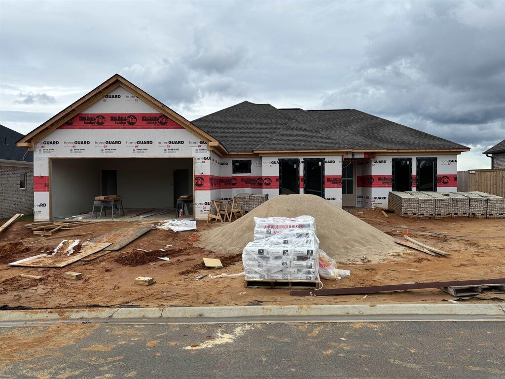 21057 Kinsley Ln, Hensley, AR 72065 - property under construction with an attached garage and roof with shingles