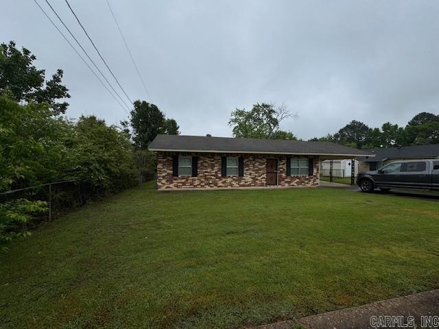 ranch-style house with a front yard and stone siding