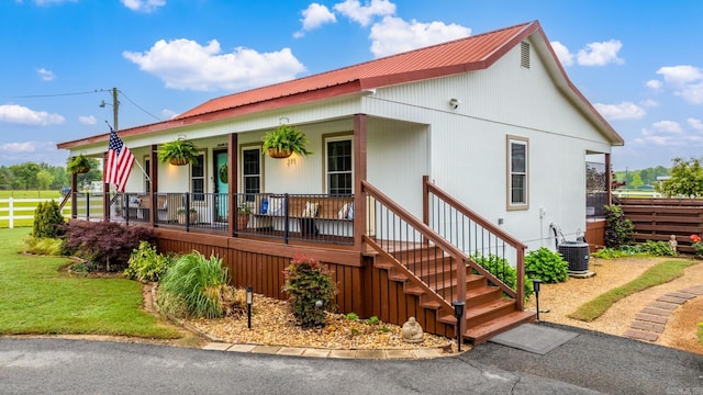 271 Austin Loop, El Paso, AR 72045 - view of front of property featuring covered porch, metal roof, and central air condition unit